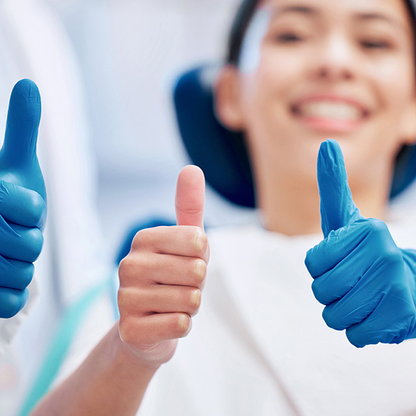 patient with thumbs up